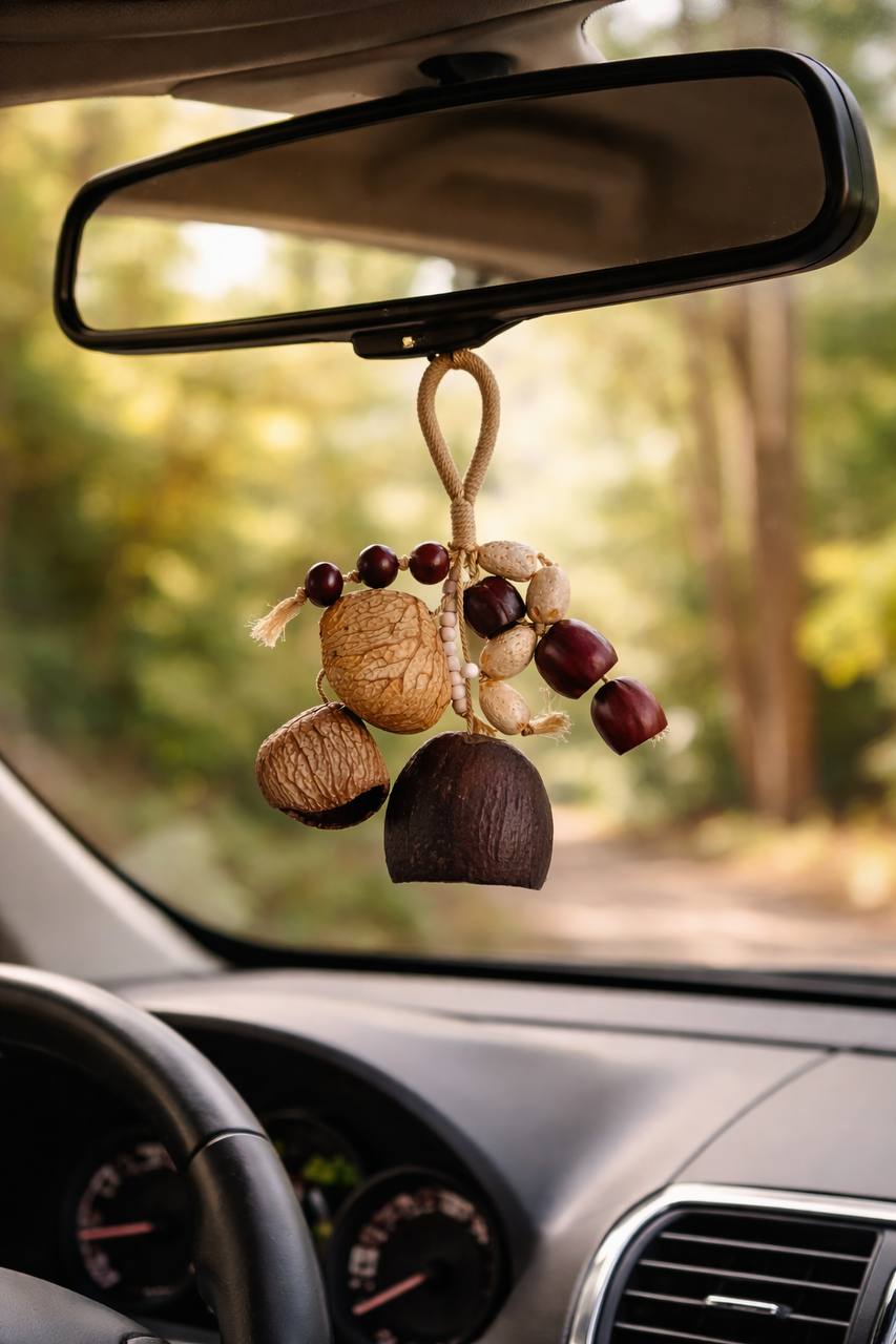 Decorative car hanging with nuts and fruits on a car's rearview mirror.