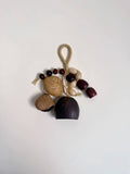 Decorative hanging with acorns, nuts, and beads on a white background