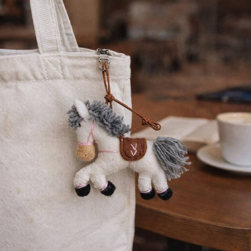 White Pony charm — on tote bag (lifestyle)
